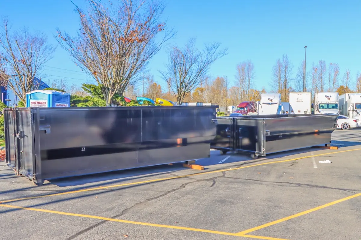 Professional dumpster rental service with roll-off container on residential driveway in Ladera Heights